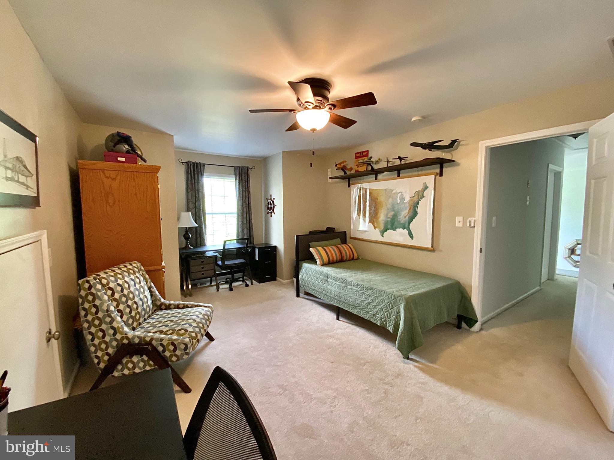 8 Augusta Street Wrightstown, NJ 08562 - Photo 23 of 44 a bedroom with furniture and a chandelier