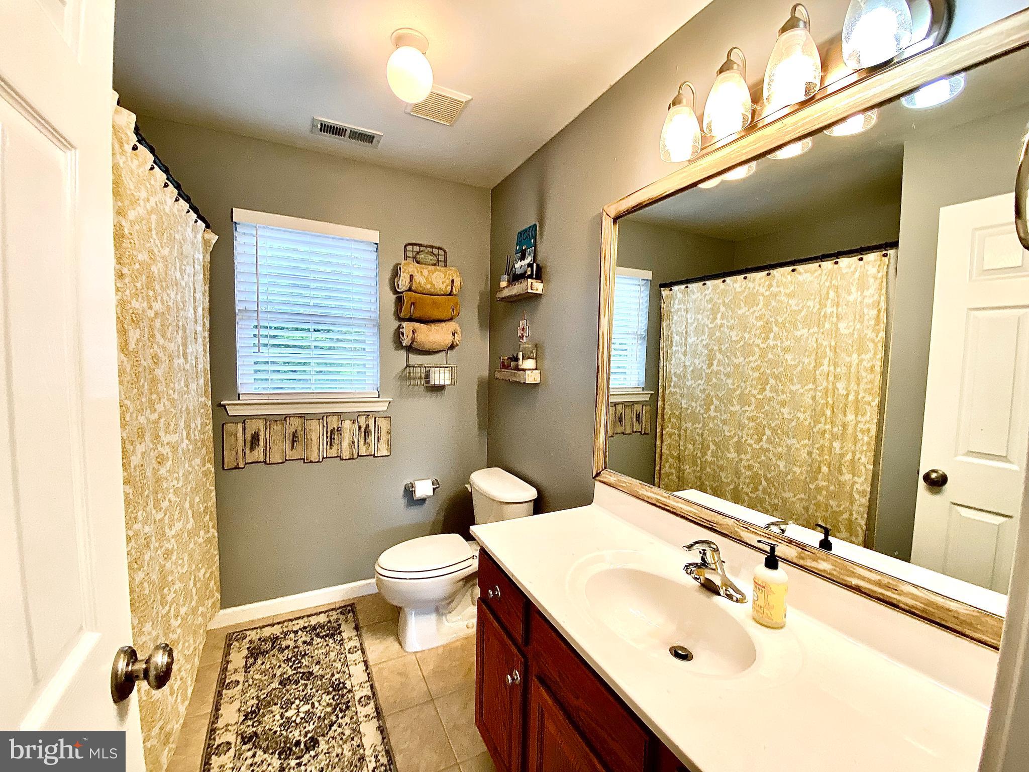 8 Augusta Street Wrightstown, NJ 08562 - Photo 24 of 44 a bathroom with a sink a toilet and shower curtain