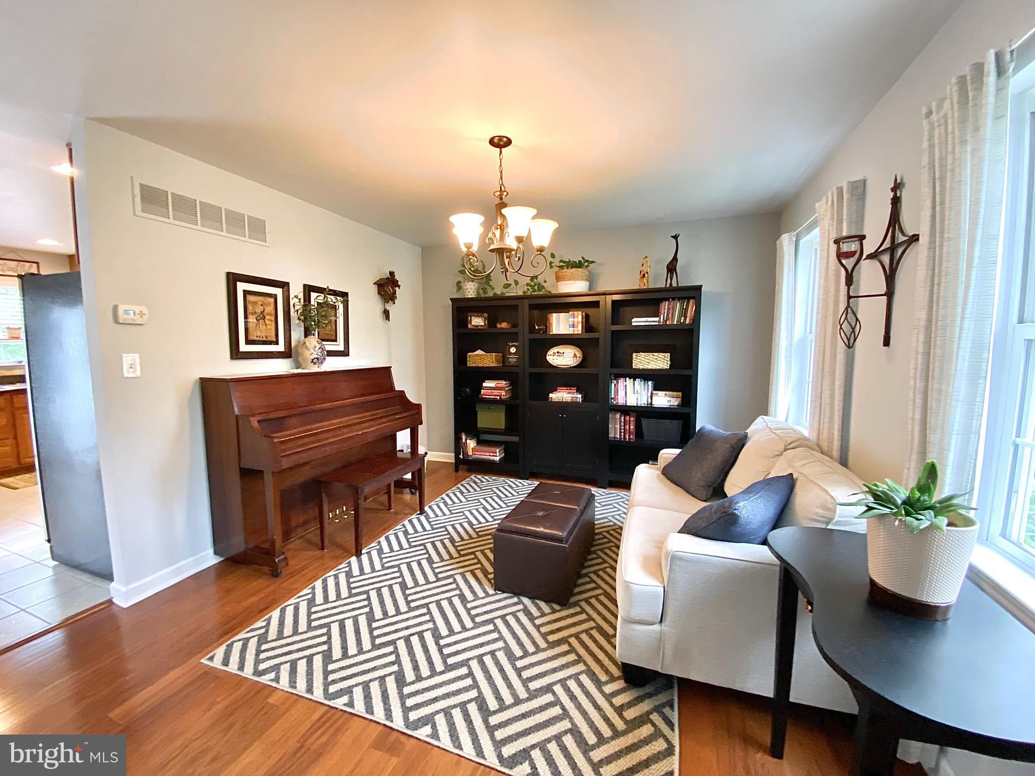 8 Augusta Street Wrightstown, NJ 08562 - Photo 5 of 44 a living room with furniture a chandelier and a dining table