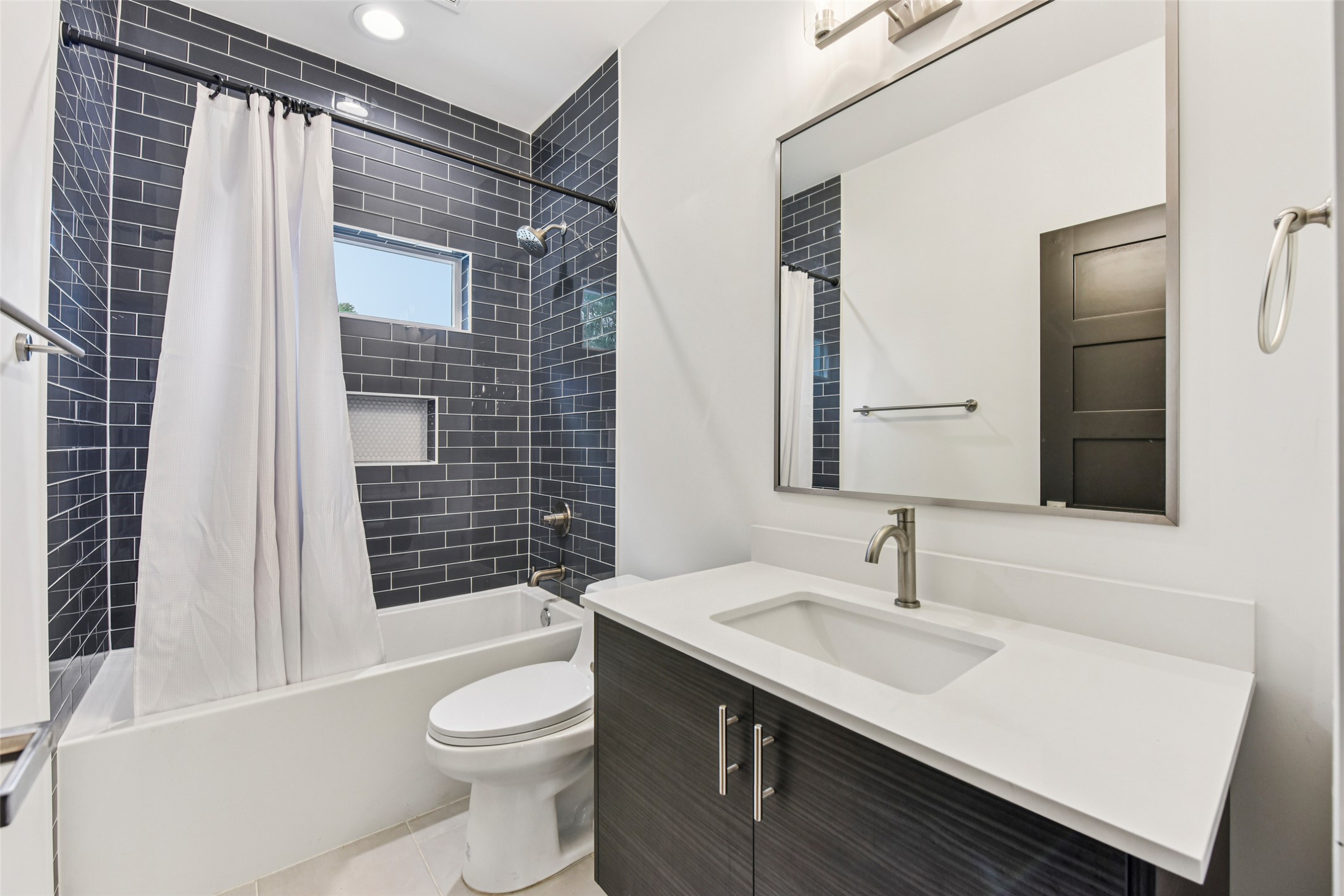 3607 Grant Street, Unit A Austin, TX 78721 - Photo 11 of 40 a bathroom with a sink a toilet and shower