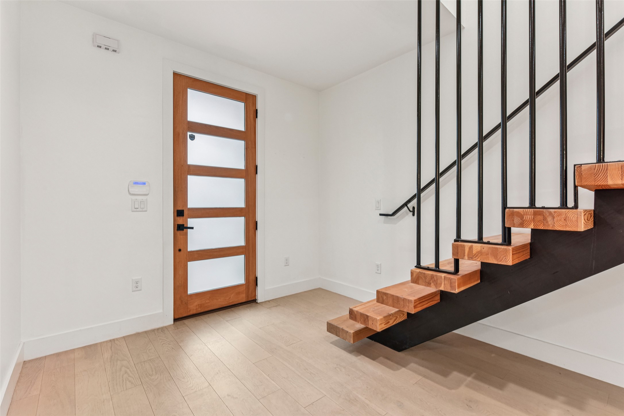 3607 Grant Street, Unit A Austin, TX 78721 - Photo 12 of 40 a view of entryway with wooden floor and stairs