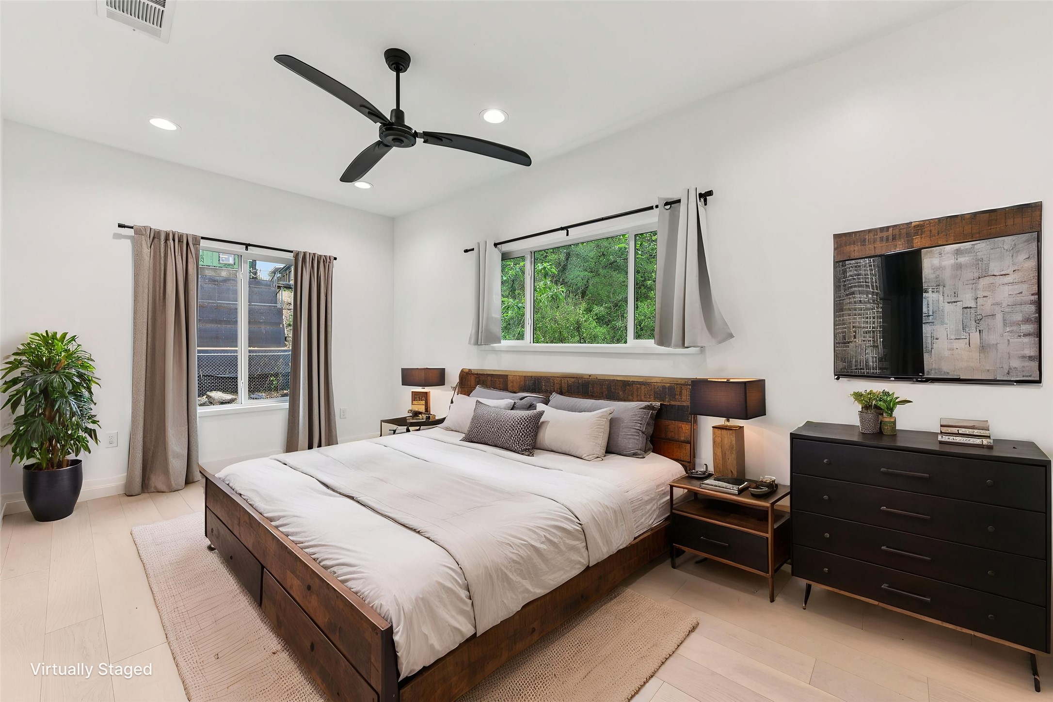 3607 Grant Street, Unit A Austin, TX 78721 - Photo 15 of 40 a bedroom with a large bed and a potted plant