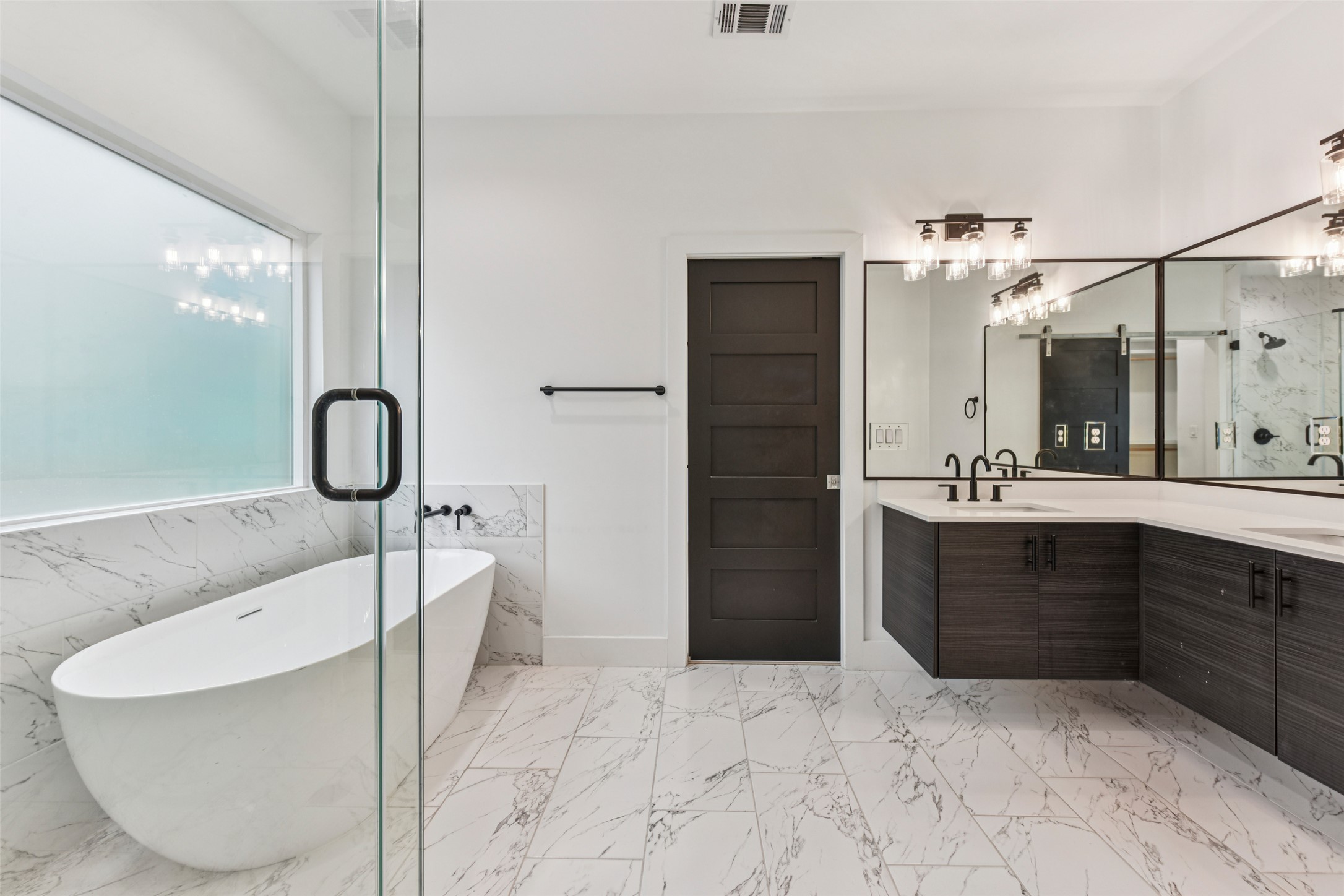 3607 Grant Street, Unit A Austin, TX 78721 - Photo 20 of 40 a bathroom with a tub sink and mirror