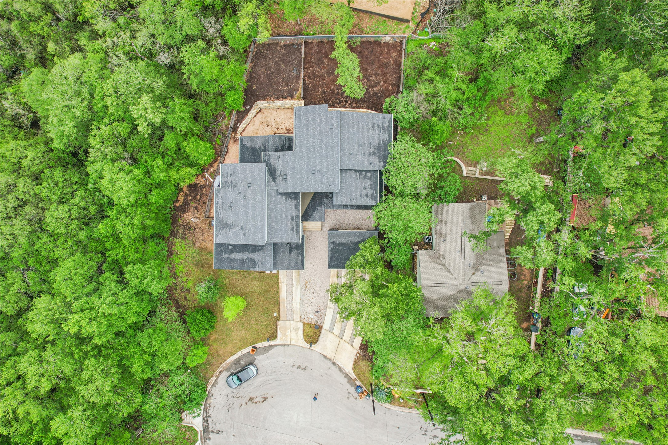 3607 Grant Street, Unit A Austin, TX 78721 - Photo 34 of 40 an aerial view of a house with a yard and trees all around