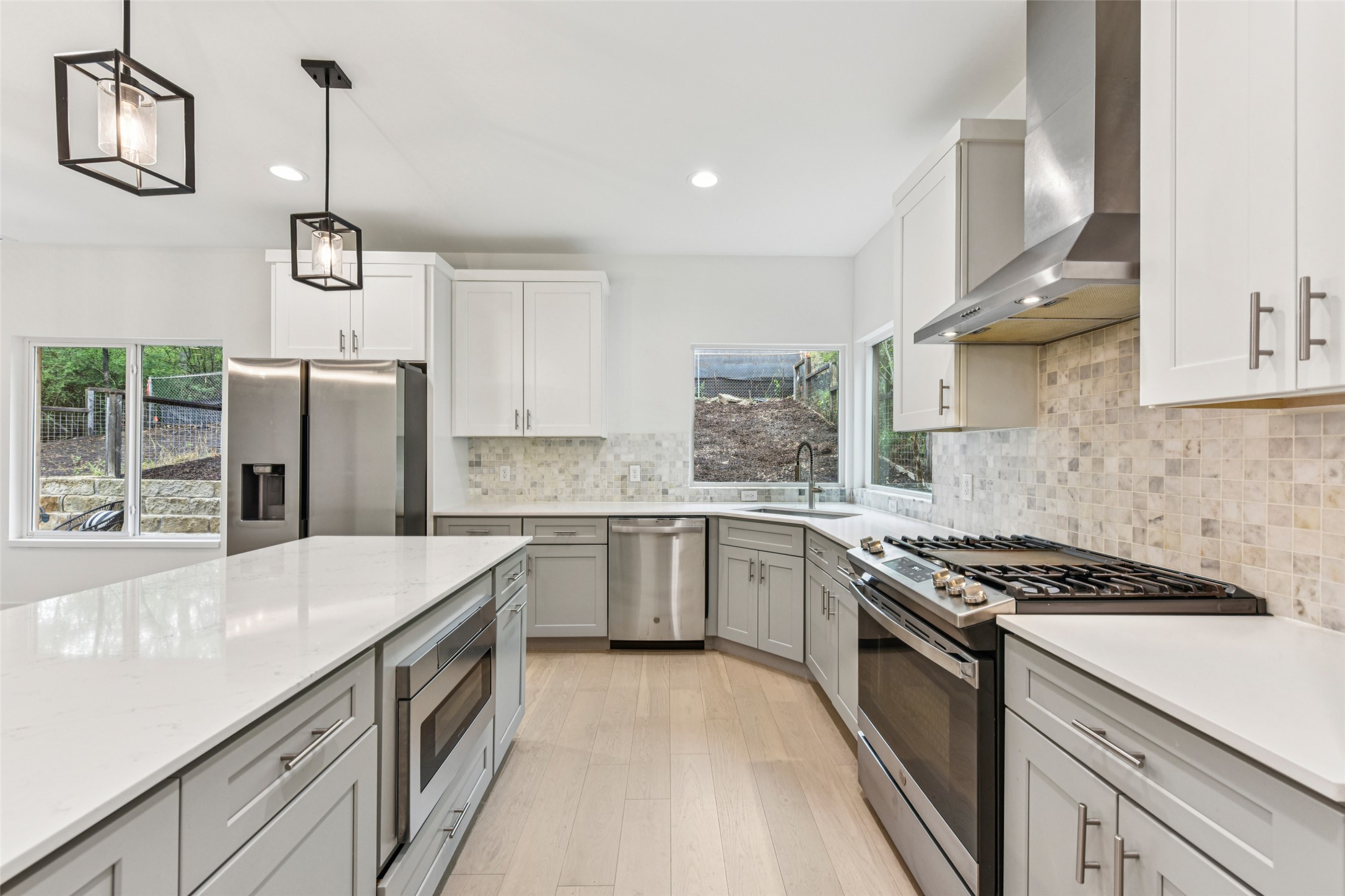 3607 Grant Street, Unit A Austin, TX 78721 - Photo 6 of 40 a kitchen with stainless steel appliances granite countertop a sink stove and refrigerator