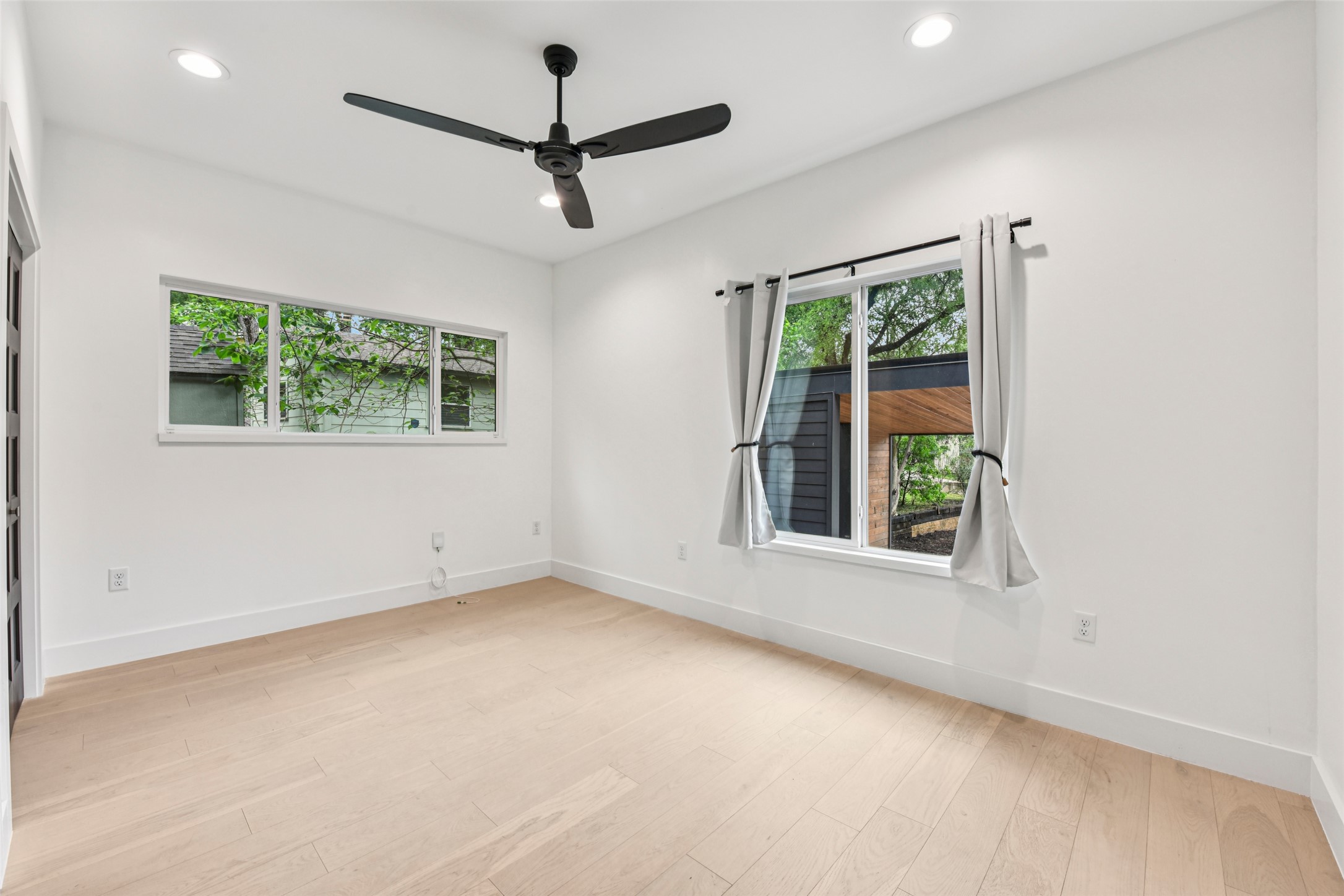 3607 Grant Street, Unit A Austin, TX 78721 - Photo 8 of 40 an empty room with a window and a ceiling fan