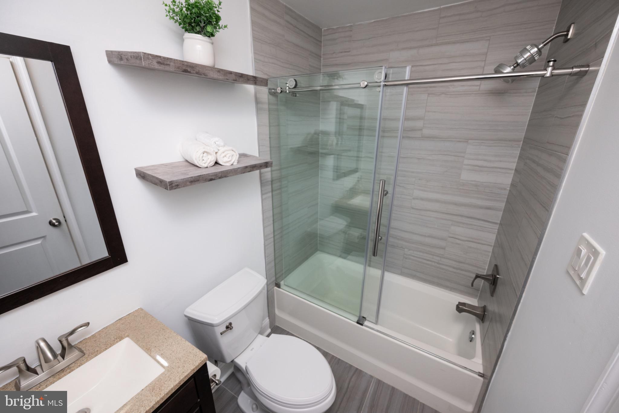 2102 Berges Street, Unit B Philadelphia, PA 19125 - Photo 16 of 29 a bathroom with a shower and toilet