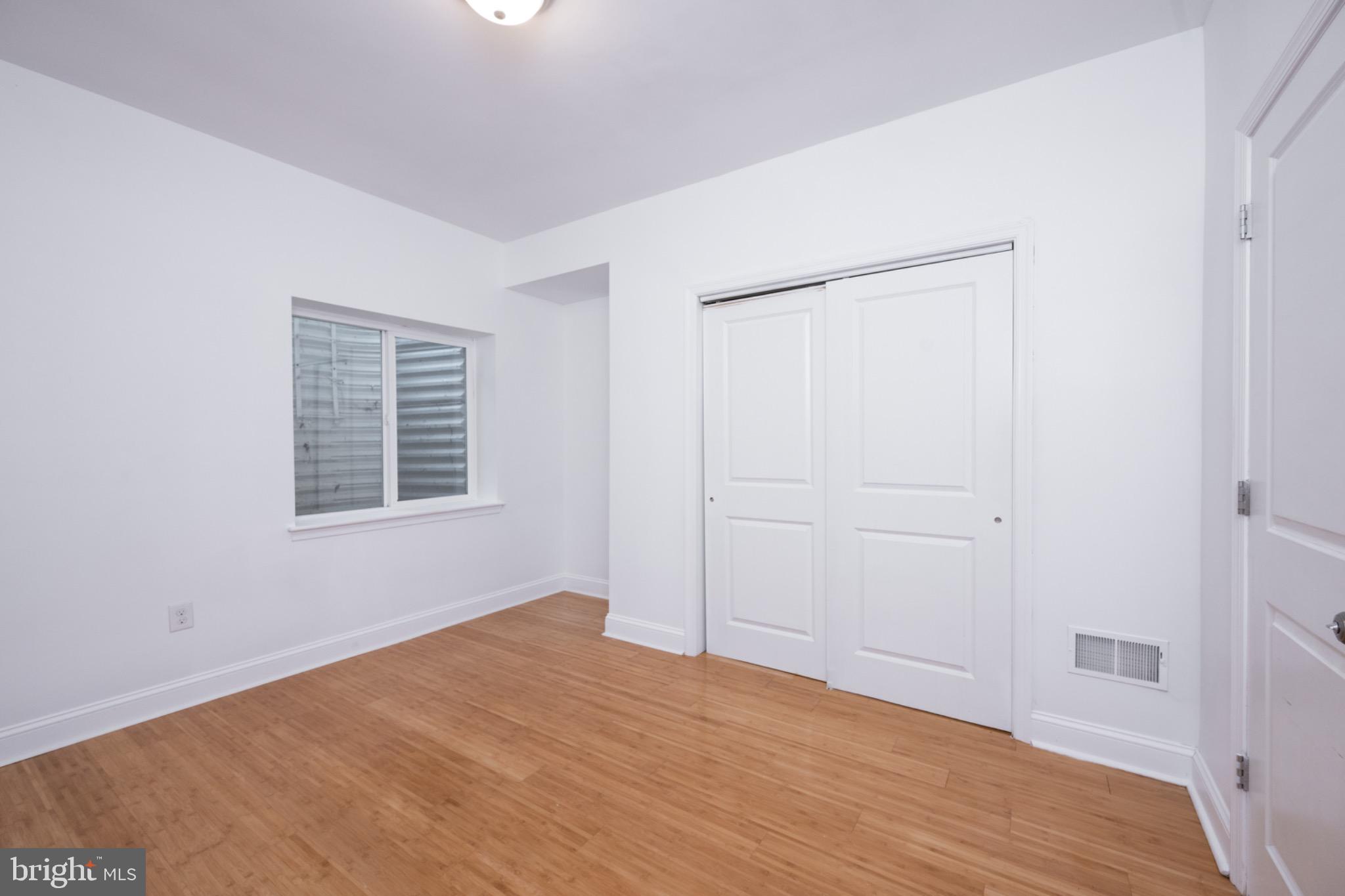 2102 Berges Street, Unit B Philadelphia, PA 19125 - Photo 17 of 29 a view of an empty room with wooden floor and a window