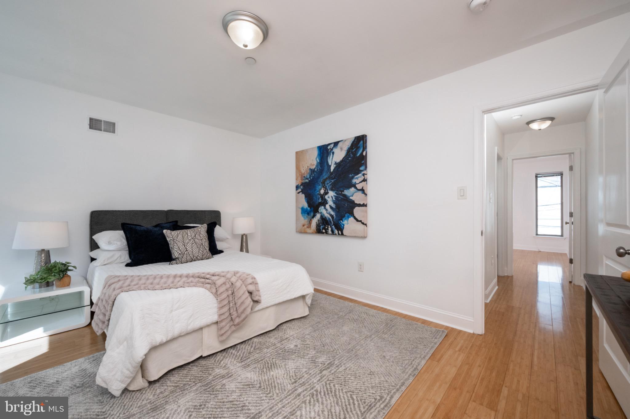 2102 Berges Street, Unit B Philadelphia, PA 19125 - Photo 23 of 29 a bedroom with a bed and a painting on the wall