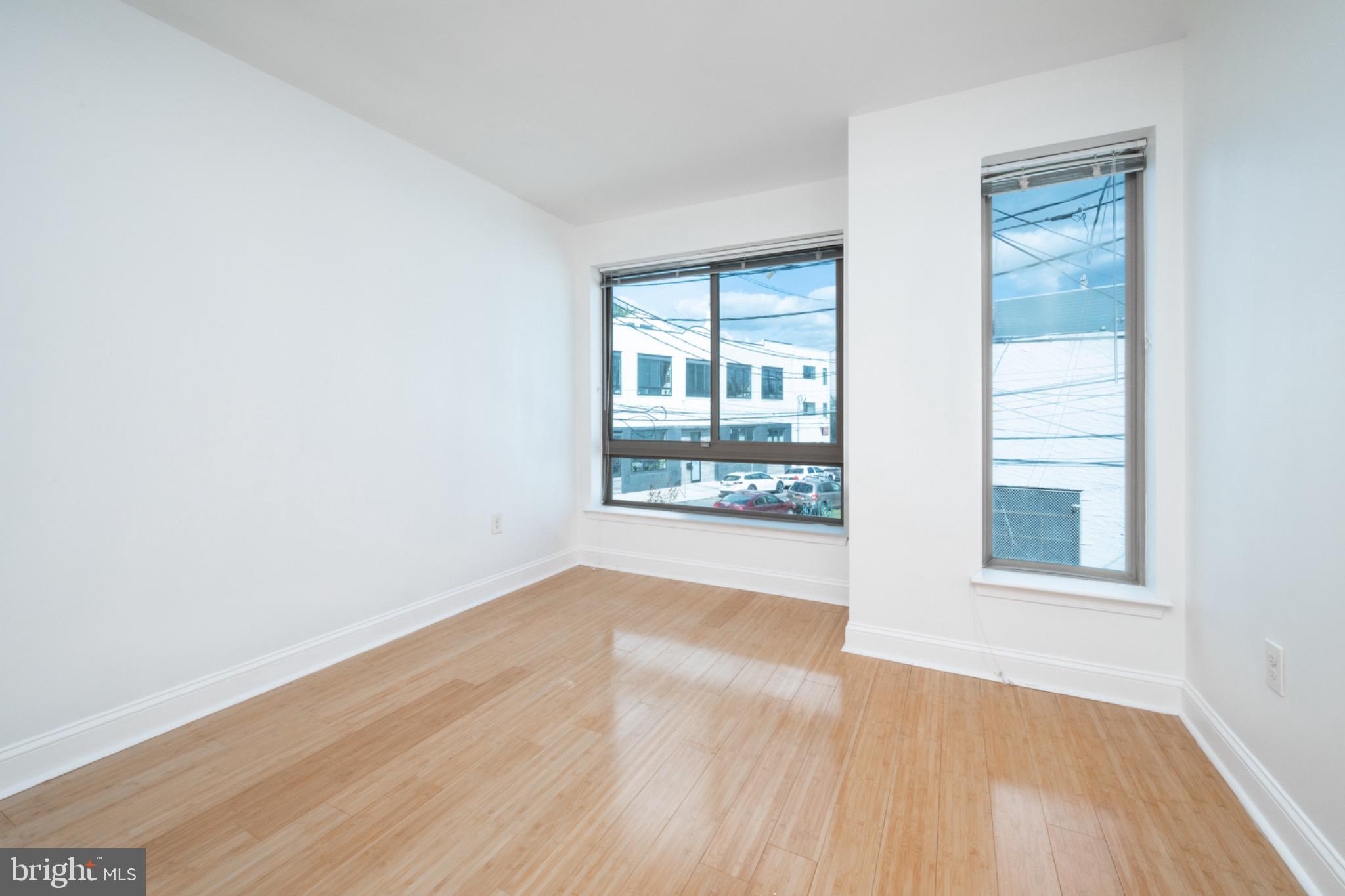 2102 Berges Street, Unit B Philadelphia, PA 19125 - Photo 25 of 29 an empty room with wooden floor and windows