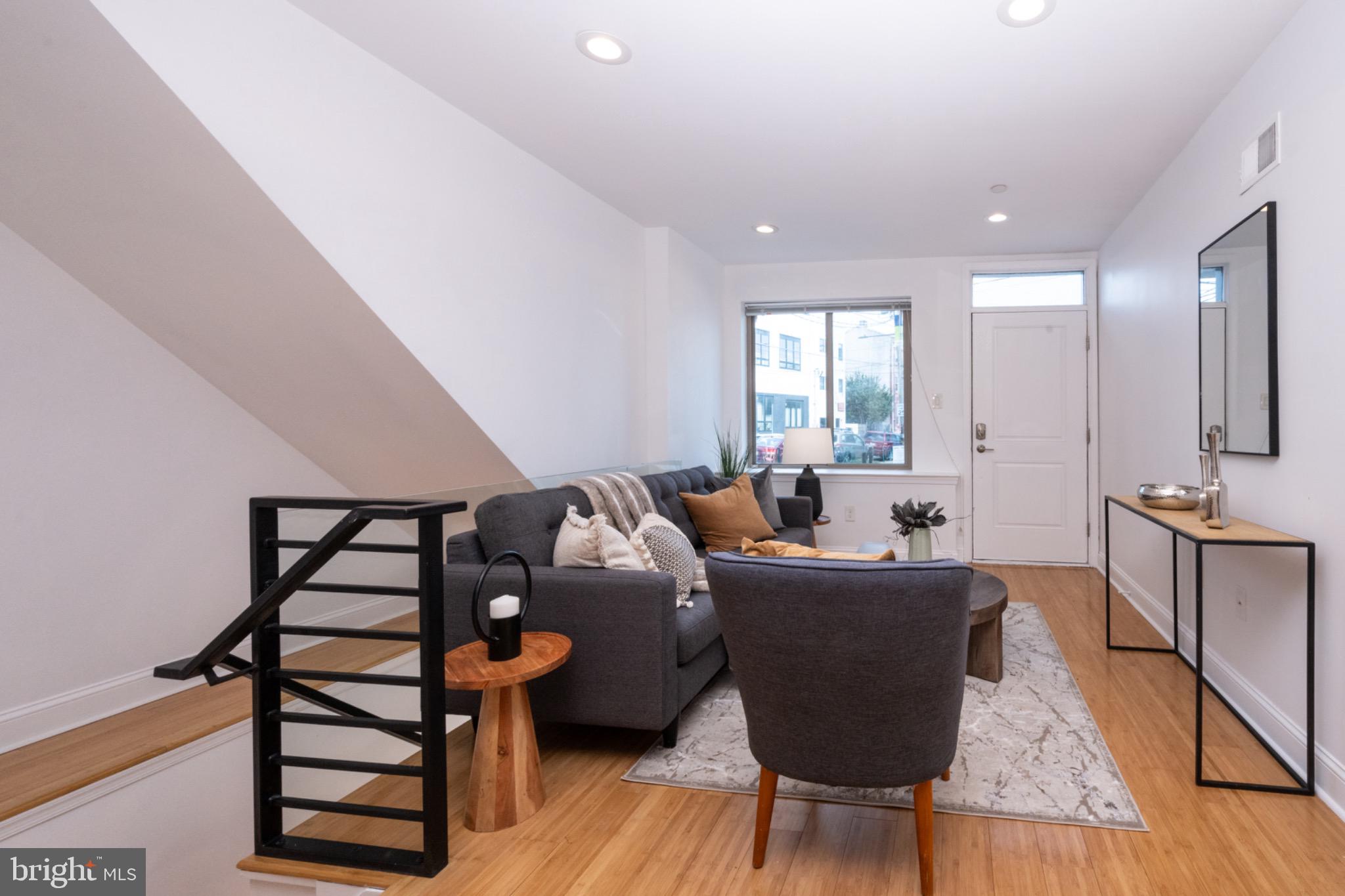 2102 Berges Street, Unit B Philadelphia, PA 19125 - Photo 3 of 29 a living room with furniture a wooden floor and a large window