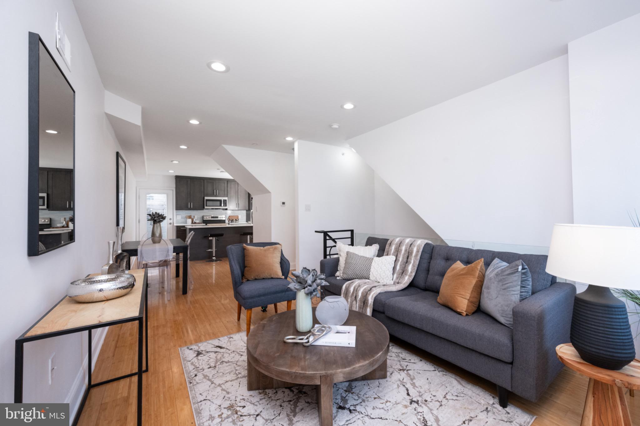 2102 Berges Street, Unit B Philadelphia, PA 19125 - Photo 7 of 29 a living room with furniture kitchen view and a table