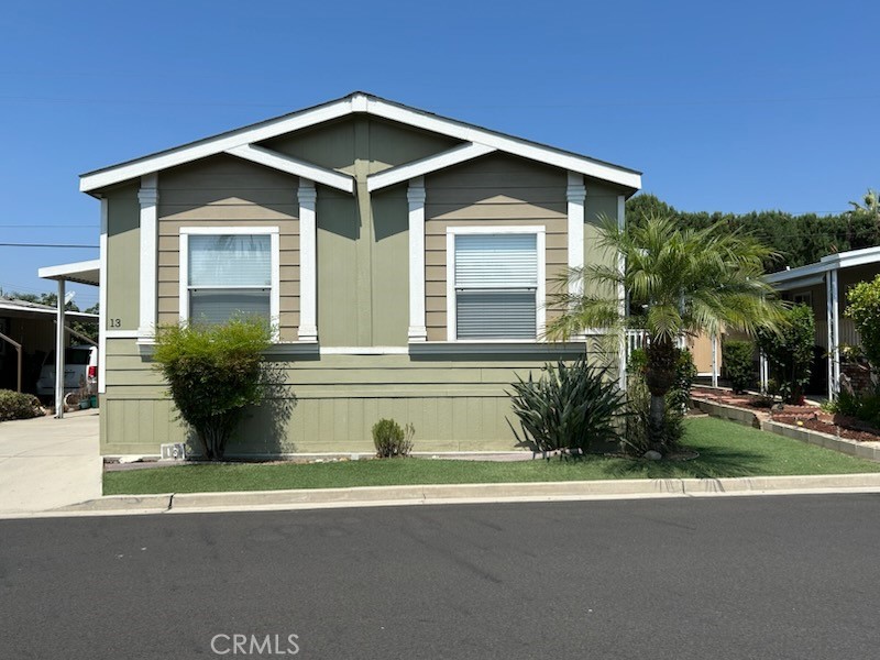 2755 Arrow Highway, Unit 13 La Verne, CA 91750 - Photo 1 of 9 a view of a house with a small yard plants and floor to ceiling window