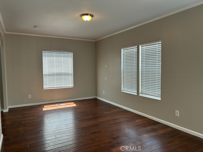 2755 Arrow Highway, Unit 13 La Verne, CA 91750 - Photo 6 of 9 an empty room with wooden floor and windows