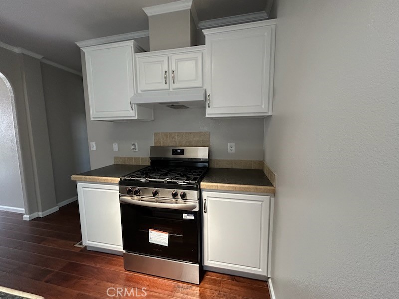 2755 Arrow Highway, Unit 13 La Verne, CA 91750 - Photo 8 of 9 a kitchen with stainless steel appliances a white stove top oven and cabinets