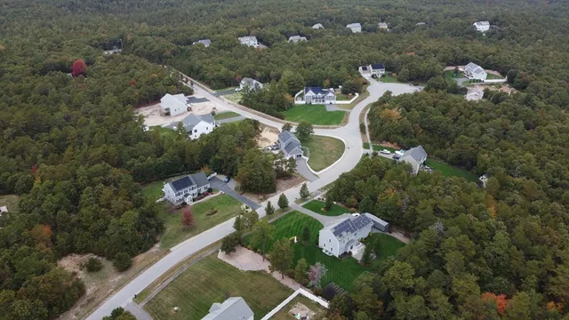 a aerial view of a house with yard swimming pool and outdoor seating