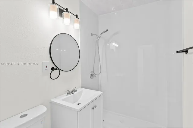 a white toilet sitting next to a bathroom sink