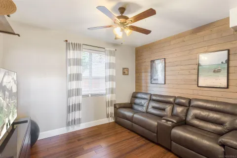 a view of a livingroom with workspace and a window