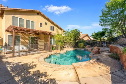 a patio with yard glass top table and chairs