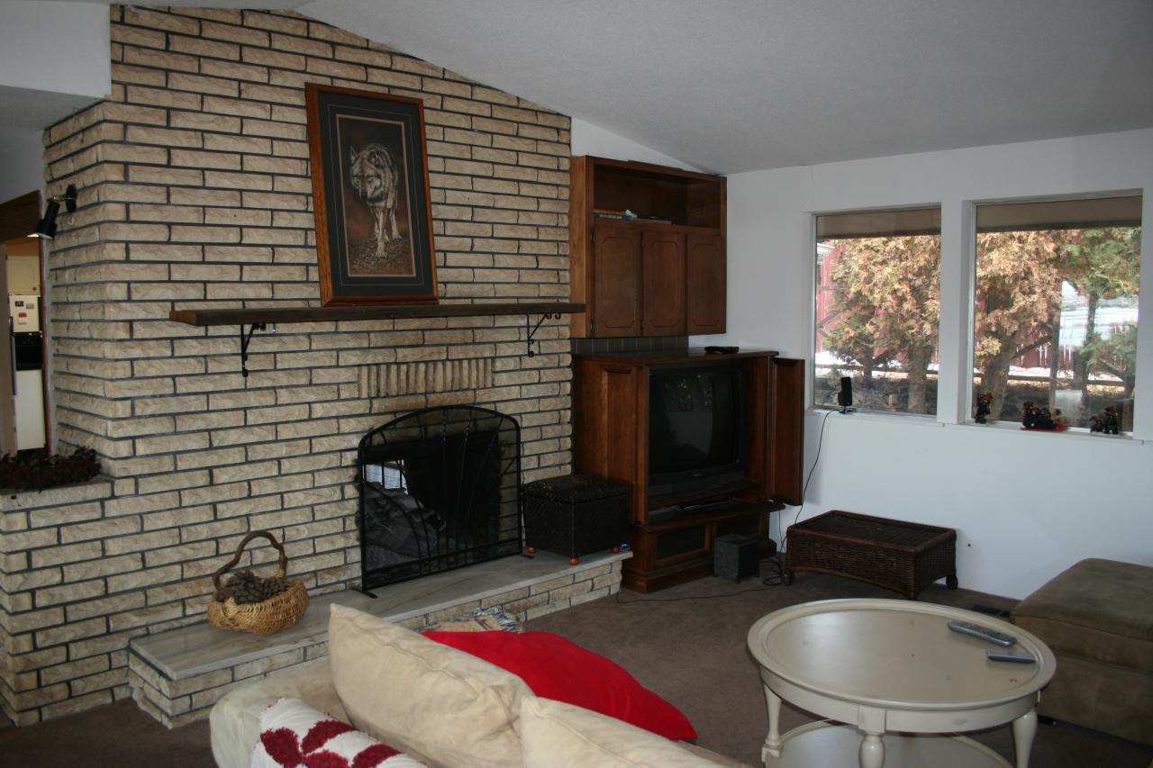 821 Livengood Road Cowiche, WA 98923 - Photo 8 of 13 a living room with furniture wooden floor and a fireplace