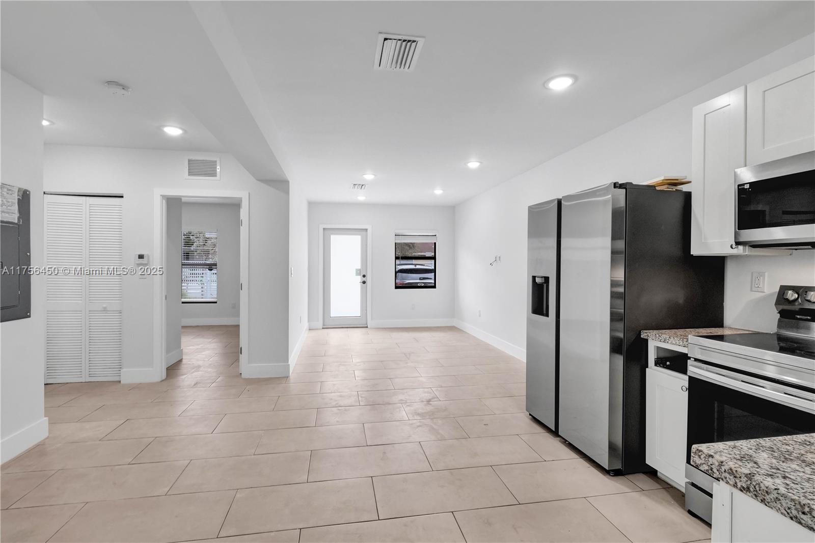 1749 Northwest 64th Street, Unit A Miami, FL 33147 - Photo 11 of 19 a view of a kitchen with refrigerator and windows