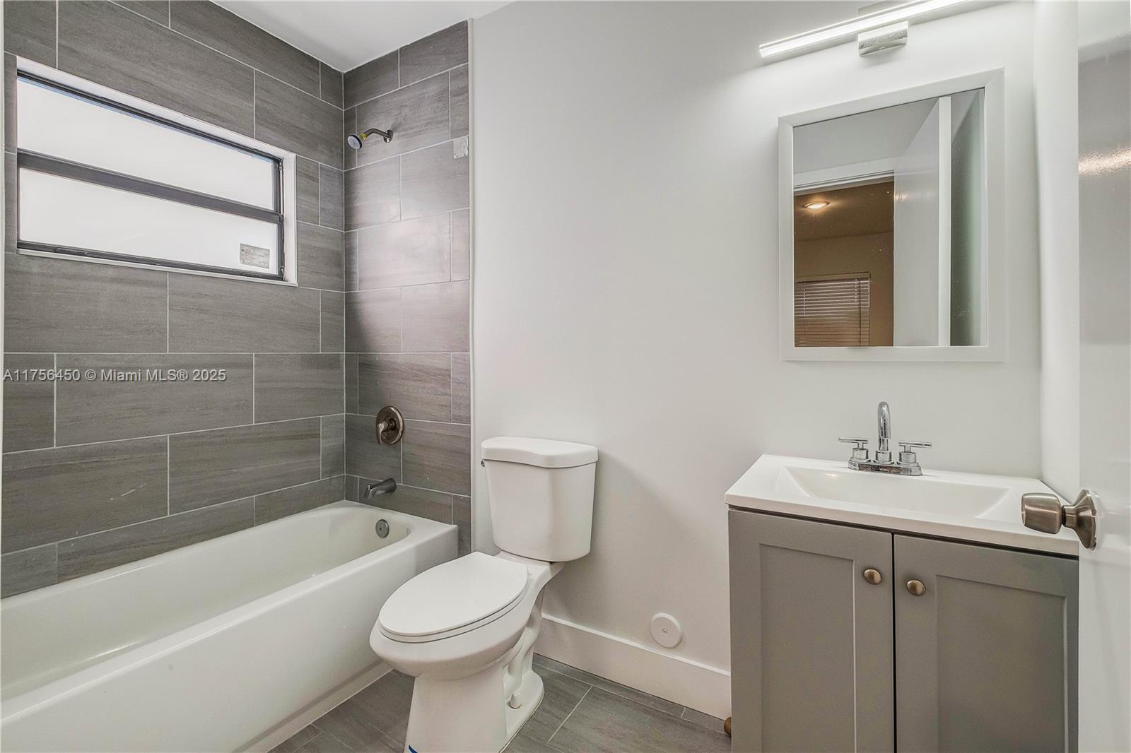 1749 Northwest 64th Street, Unit A Miami, FL 33147 - Photo 15 of 19 a bathroom with a sink toilet and bathtub