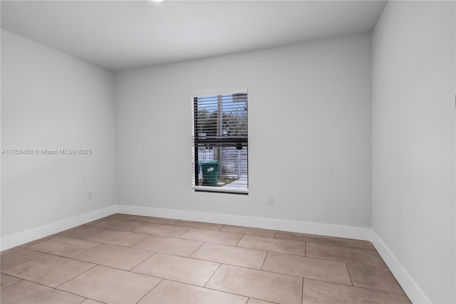 1749 Northwest 64th Street, Unit A Miami, FL 33147 - Photo 17 of 19 a view of an empty room and window
