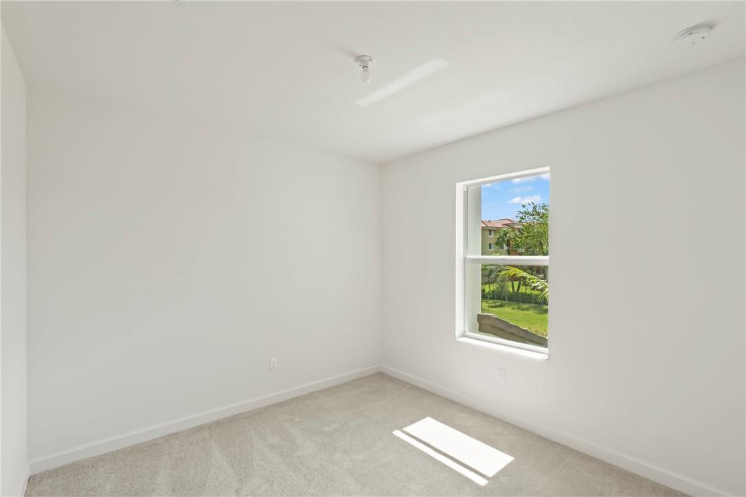 5714 Veranda Way, Unit 2 Boca Raton, FL 33433 - Photo 7 of 24 an empty room with windows