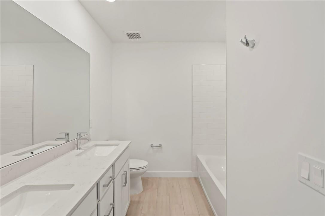 5714 Veranda Way, Unit 2 Boca Raton, FL 33433 - Photo 8 of 24 a bathroom with a sink a toilet and shower