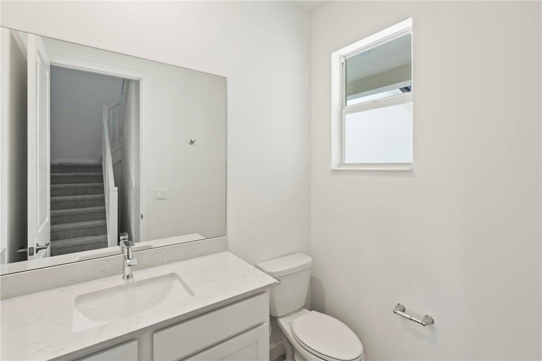 5714 Veranda Way, Unit 2 Boca Raton, FL 33433 - Photo 10 of 24 a bathroom with a toilet a sink and mirror