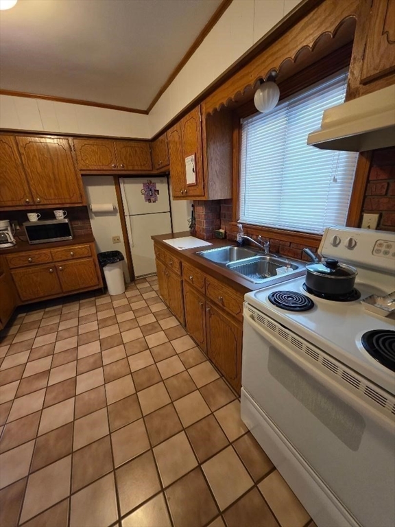 478 Tucker Street Fall River, MA 02721 - Photo 7 of 38 a kitchen with a sink and a stove top oven