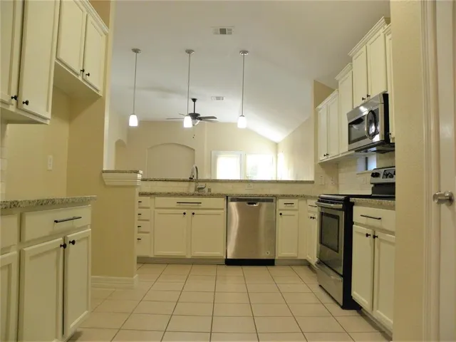 a kitchen with a stove a sink and a refrigerator