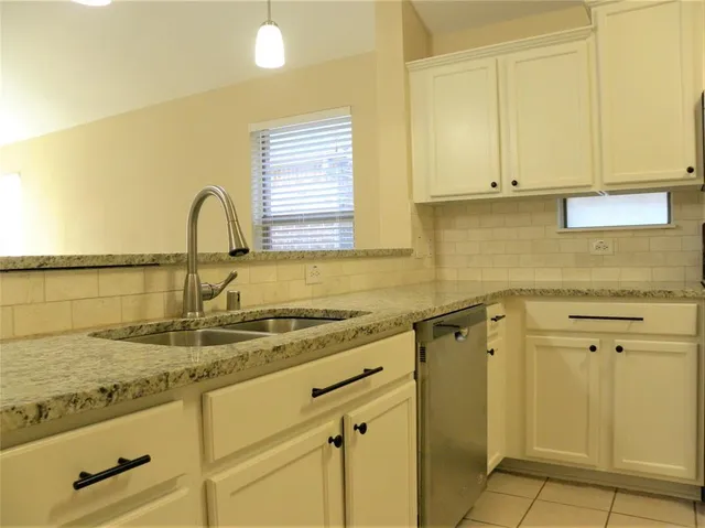 a kitchen with stainless steel appliances granite countertop a sink and cabinets