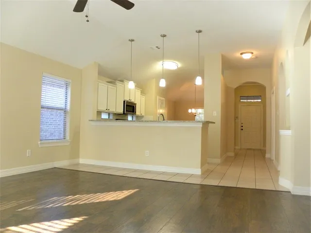 a view of a kitchen with a sink and cabinets