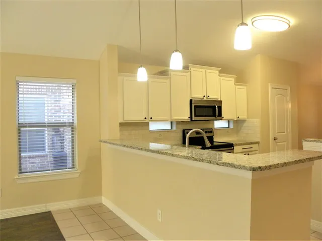 a kitchen with a sink appliances and a counter top space