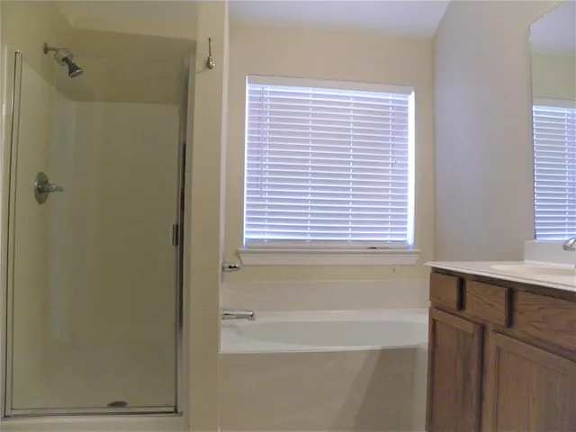a bathroom with a bathtub and a shower