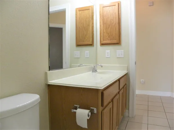 a bathroom with a sink a toilet and mirror