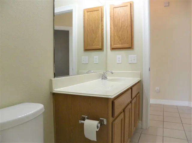 a bathroom with a sink a toilet and mirror