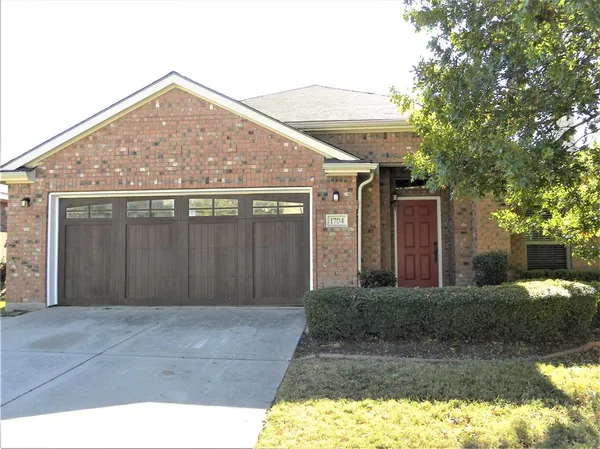 a front view of house with yard and trees around