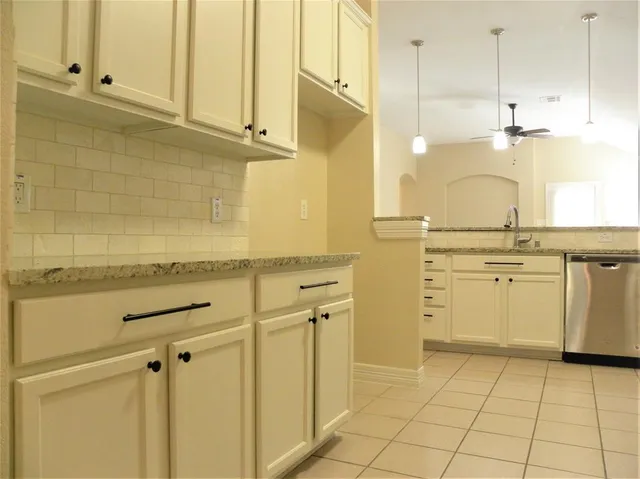 a view of a kitchen with white cabinets
