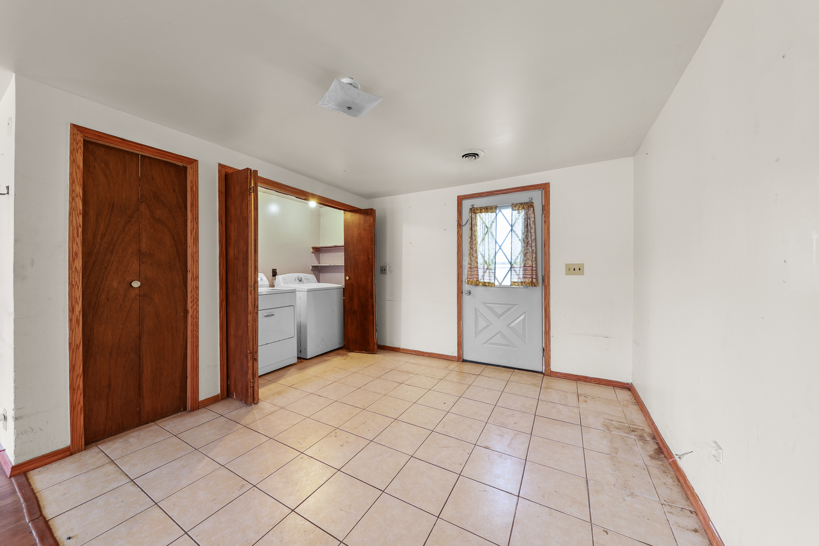 299 East Lincoln Street Seneca, IL 61360 - Photo 7 of 17 a view of an empty room with window and wooden floor