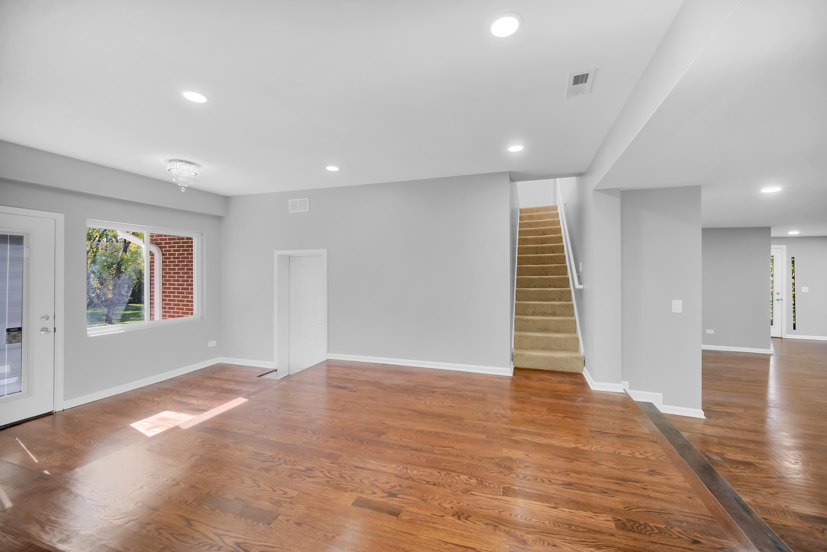 28W360 Roosevelt Road Winfield, IL 60190 - Photo 12 of 50 an empty room with wooden floor and windows