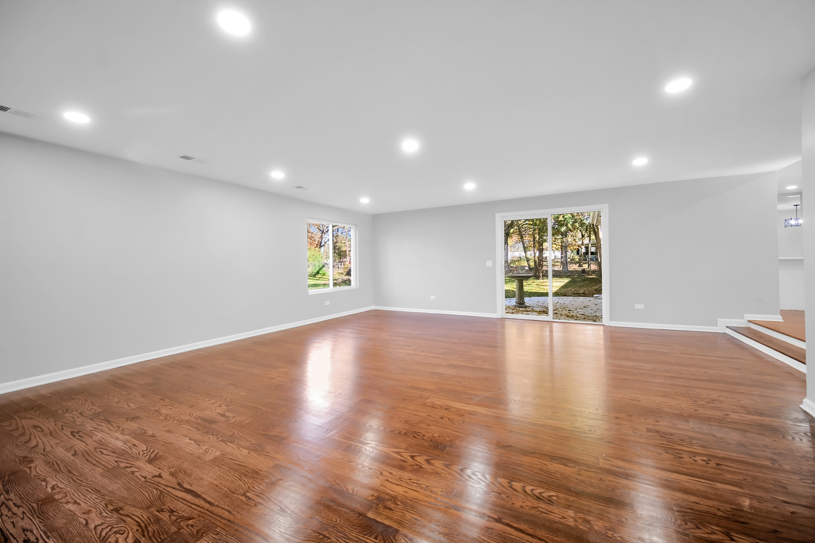 28W360 Roosevelt Road Winfield, IL 60190 - Photo 13 of 50 a view of an empty room with wooden floor and a window