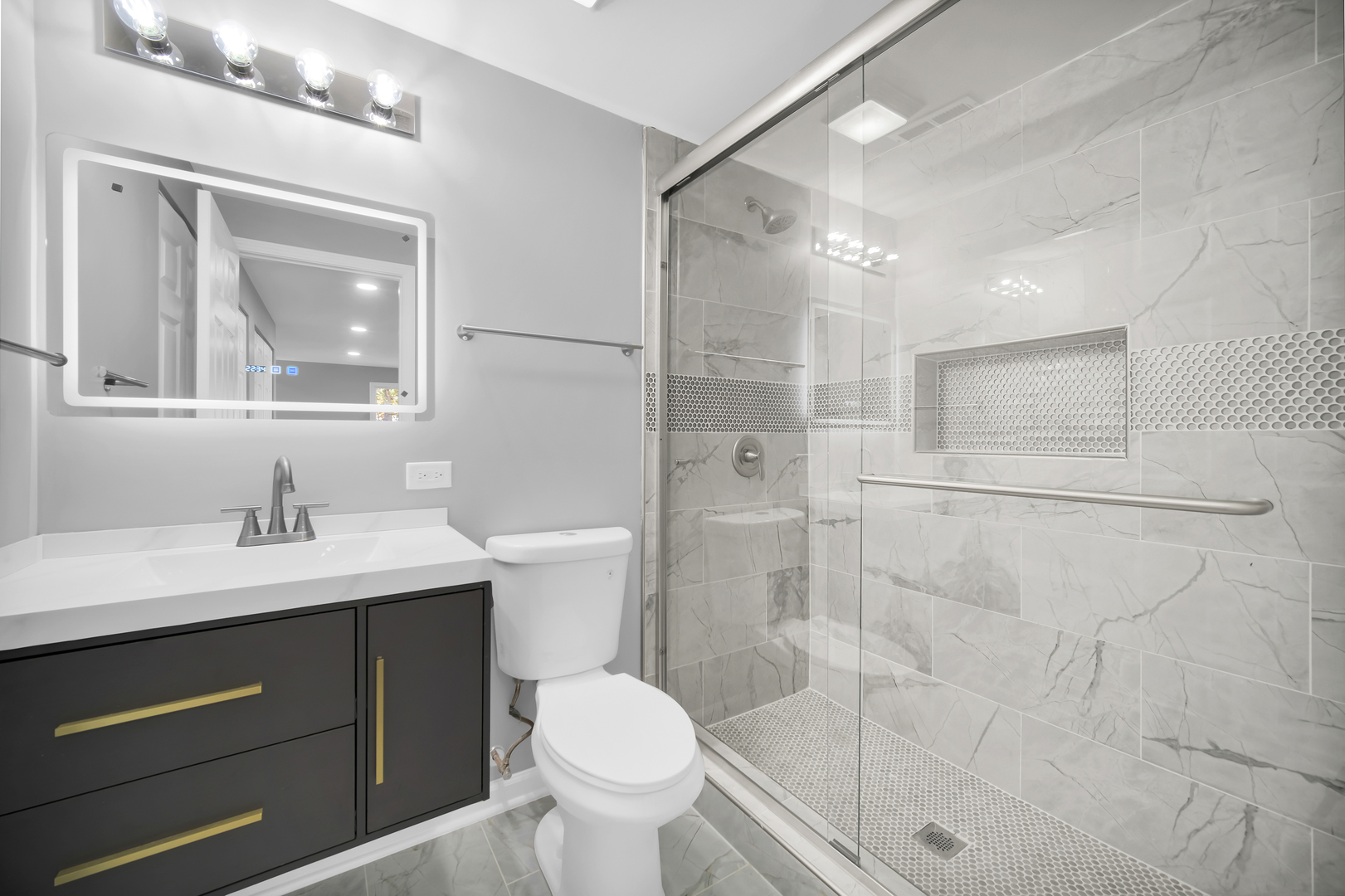 28W360 Roosevelt Road Winfield, IL 60190 - Photo 15 of 50 a bathroom with a sink toilet a mirror and shower