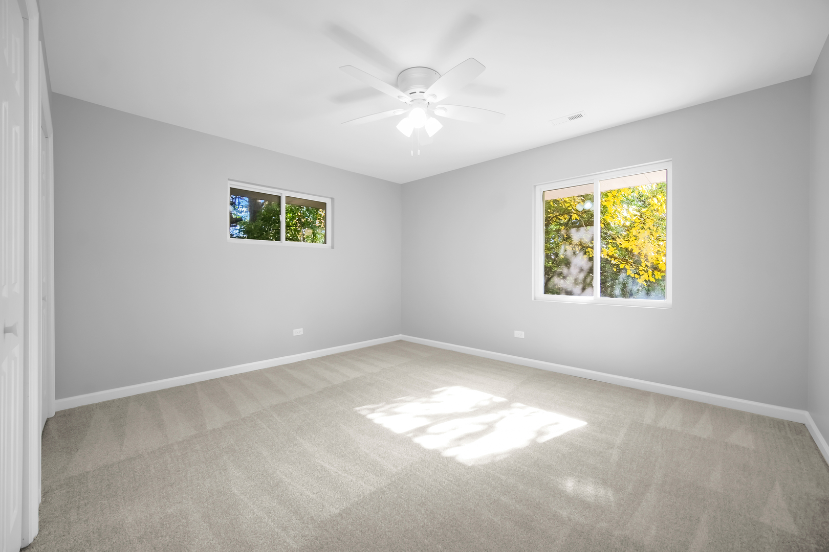 28W360 Roosevelt Road Winfield, IL 60190 - Photo 20 of 50 an empty room with windows and fan