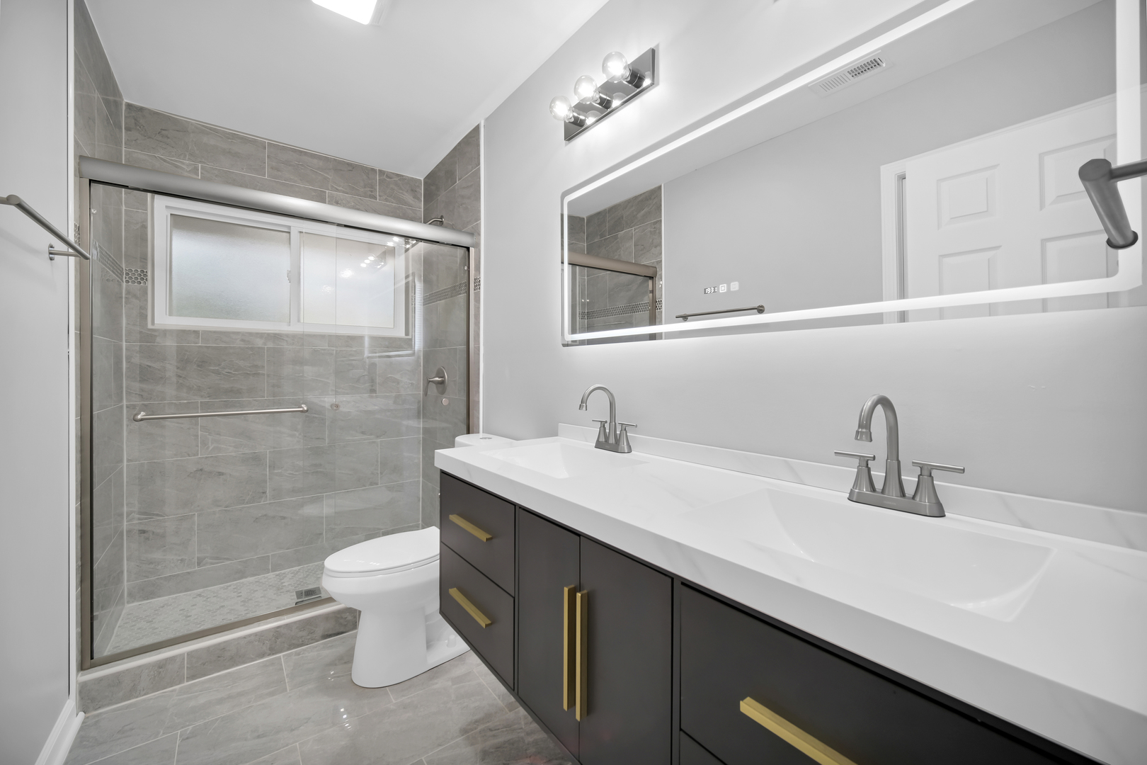 28W360 Roosevelt Road Winfield, IL 60190 - Photo 21 of 50 a bathroom with a sink a toilet and shower