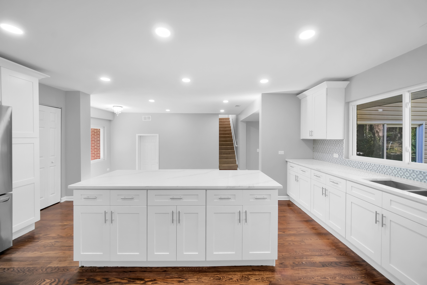 28W360 Roosevelt Road Winfield, IL 60190 - Photo 24 of 50 a large white kitchen with kitchen island white cabinets and refrigerator