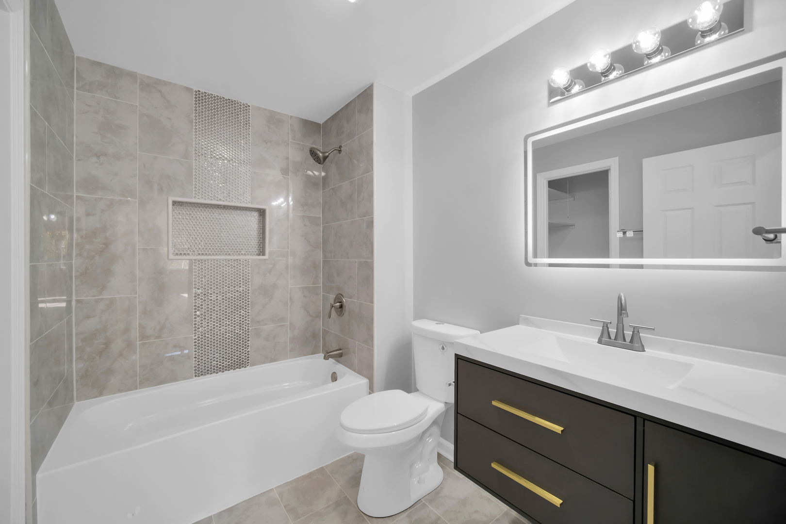 28W360 Roosevelt Road Winfield, IL 60190 - Photo 30 of 50 a bathroom with a sink a toilet and shower