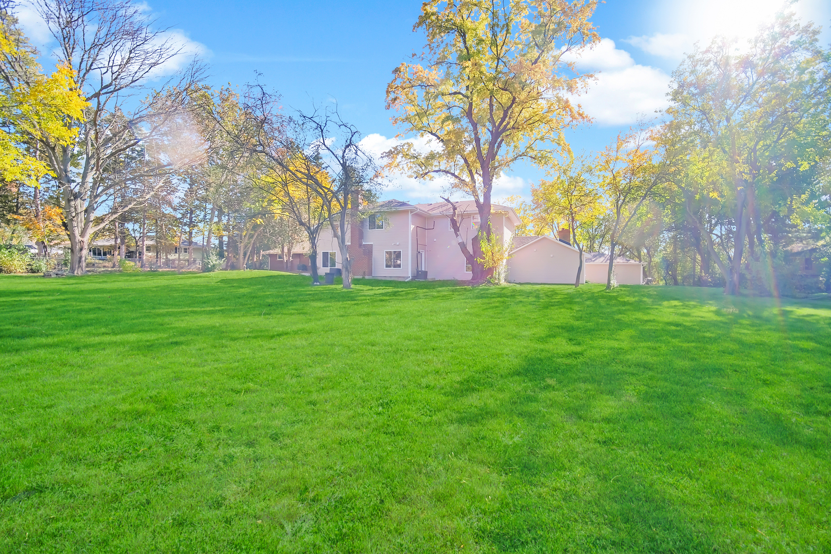 28W360 Roosevelt Road Winfield, IL 60190 - Photo 43 of 50 a backyard of a house with lots of green space and fountain