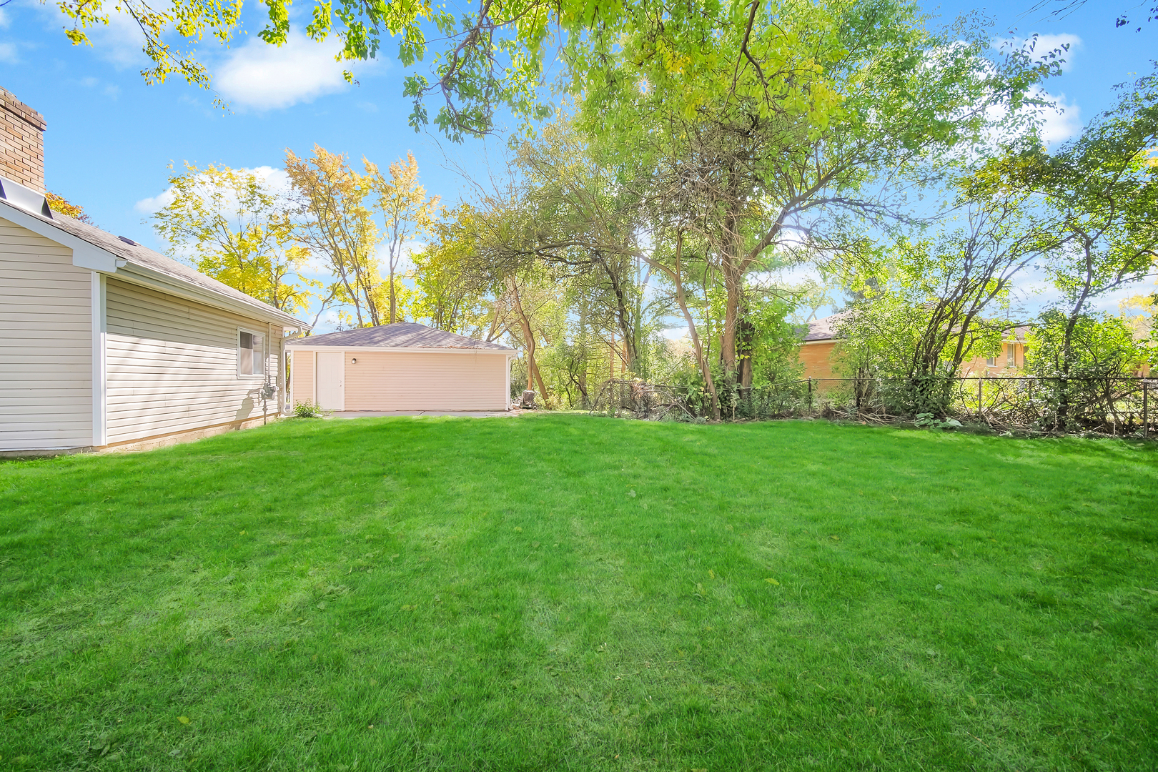 28W360 Roosevelt Road Winfield, IL 60190 - Photo 45 of 50 a view of a backyard with plants and large trees